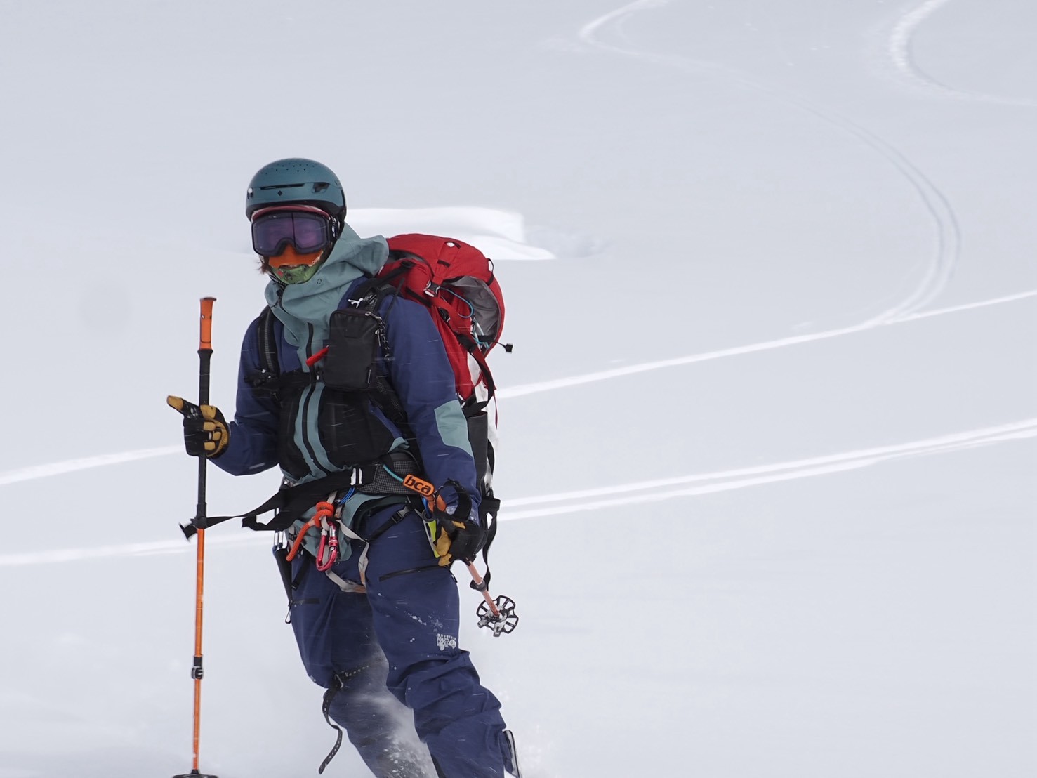 Skier standing on powder slope ready to drop in